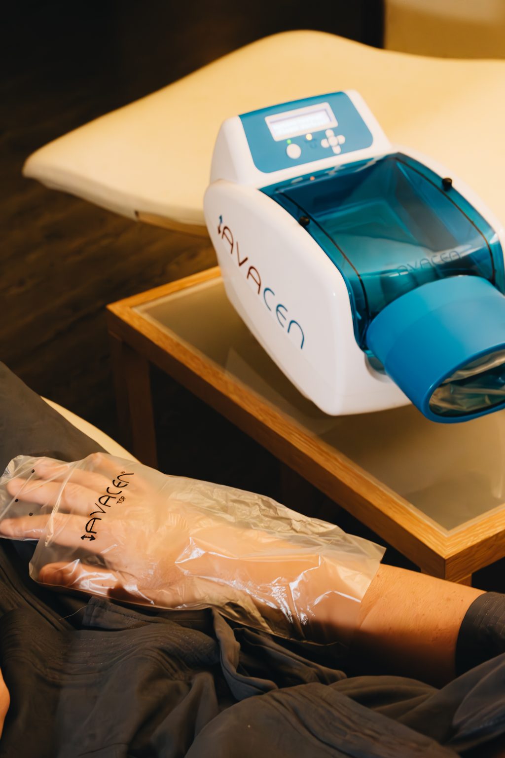 a person's hand in a plastic glove next to a machine