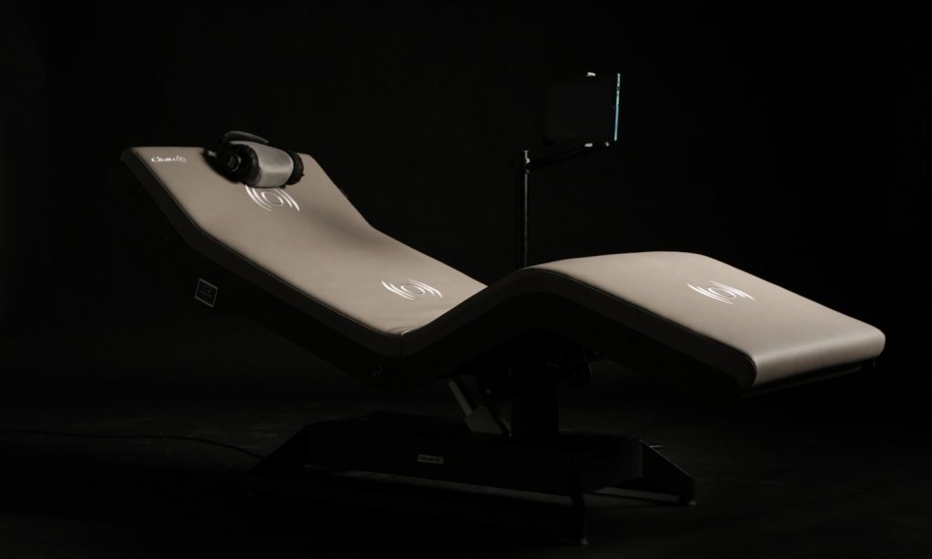 A gray reclining chair with headphones on it